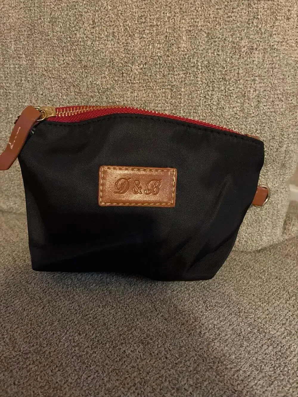 Dooney & Bourke Wayfarer Zip Tote in black nylon with Vachetta leather trim. Wit